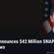 Fostoria News Man in suit with American flag in background, news headline about SNAP fraud crackdown.